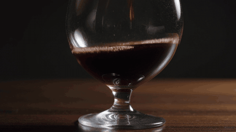 Red wine swirling slowly in a glass